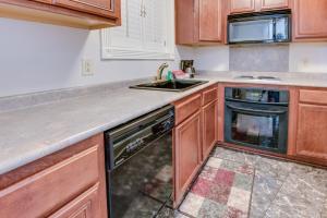 a kitchen with a sink and a dishwasher at LA Plaza Apartments in Metairie