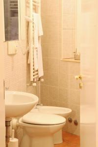 a bathroom with a white toilet and a sink at Agora nei Sassi in Matera