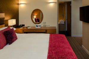a bedroom with a large bed and a mirror at Leopold Hotel in Sheffield