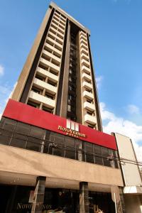 a tall building with a clock on the front of it at Rede Andrade Vernon in Curitiba