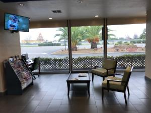 a waiting room with chairs and a tv in a store at Americas Best Value Inn Vacaville in Vacaville