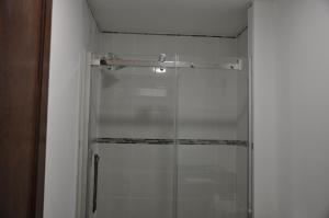 a shower with a glass door in a bathroom at Ambassador's Inn Next Door in Stratford +57 photos