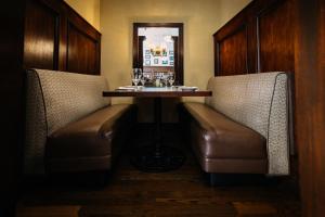a restaurant with two chairs and a table with wine glasses at Downtown Grand Hotel & Casino in Las Vegas