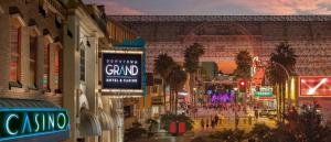 a city street at night with people walking down the street at Downtown Grand Hotel & Casino in Las Vegas