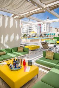 a patio with green and yellow furniture on a roof at Downtown Grand Hotel & Casino in Las Vegas