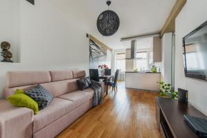 a living room with a couch and a table at Chmielna Warsaw Cental Station P&O Serviced Apartments in Warsaw