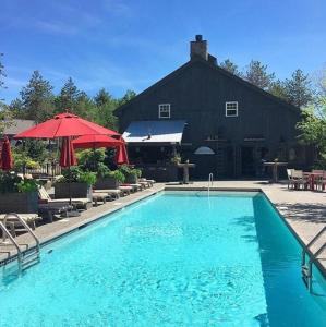 a large swimming pool in front of a black building at Hidden Pond Resort in Kennebunkport