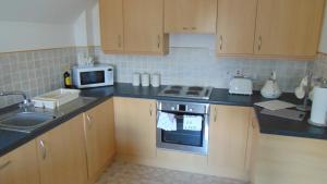 a kitchen with a sink and a stove top oven at Montclaire in Ballater