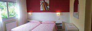 Łóżko lub łóżka w pokoju w obiekcie Hotel La Costera