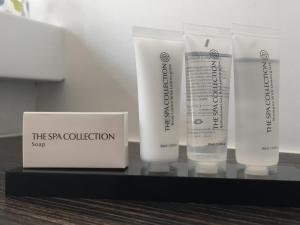 three tubes of sunscreen on a shelf with a box at B&B Sabbajon in Ieper