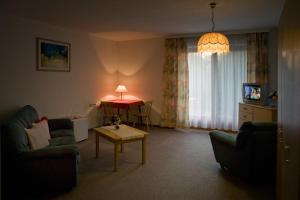 a living room with a couch and a table at Edelweisshof in Birnbaum
