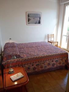 a bedroom with a bed with a table and a picture at Etrusco Antico in Capodimonte