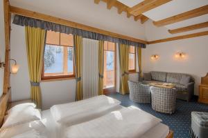 Postel nebo postele na pokoji v ubytování Hotel Garni Elisir