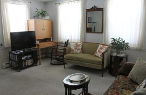 a living room with a couch and a tv at Northey Street House in Salem