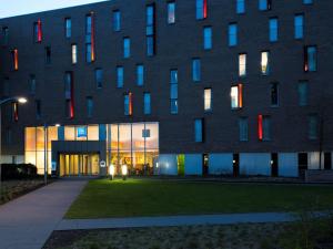 a building with colorful windows on the side of it at ibis budget Brugge Centrum Station in Bruges