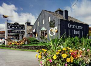 a black building with flowers in front of it at Greenbrier Inn Killington in Killington