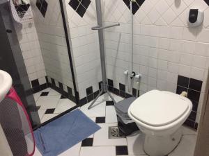 a bathroom with a toilet and a shower stall at Casa da Brigite in Porto Alegre