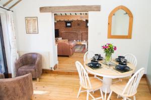 a dining room with a table and chairs at The Stables in Southwell in Southwell