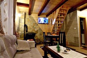 a living room with a couch and a table and a fireplace at Holiday Home Perduh in Sekulić 