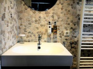 a bathroom with a sink and a mirror at B & B Villa Suisse in Scheveningen