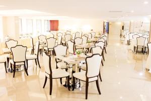 a dining room with tables and chairs at Guangzhou Jin Wan Li Business Hotel in Guangzhou
