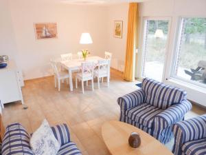 ein Wohnzimmer mit Tisch und Stühlen in der Unterkunft Ferienwohnung *Wibkes Hüs* in Wittdün + 20 Fotos