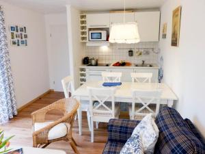 a kitchen and dining room with a white table and chairs at Hüs Sanskiin Ferienwohnung *Hopelfask* in Süddorf +62 photos