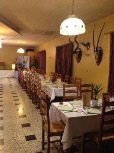 a long dining room with white tables and chairs at Bel Air in Marville
