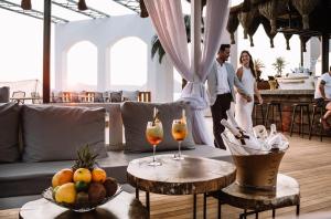 a bride and groom standing in a living room with drinks at Yalikavak Marina Garden Hotel in Yalıkavak