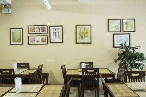 a dining room with tables and chairs and pictures on the wall at GV Hotel - Valencia in Valencia