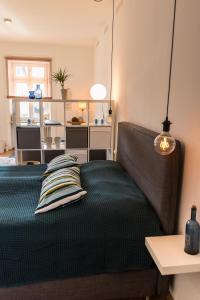 a bedroom with a bed with a green comforter at Loft Apartment Limburg in Limburg an der Lahn