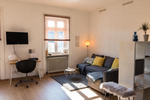 a living room with a couch and a chair at Loft Apartment Limburg in Limburg an der Lahn