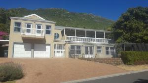 a large yellow house with a lot of windows at Sandpiper's Nest - Hout Bay in Hout Bay