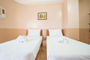 Postel nebo postele na pokoji v ubytování GV Hotel - Tagbilaran City