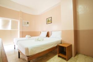 Postel nebo postele na pokoji v ubytování GV Hotel - Tagbilaran City