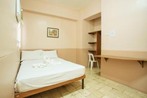 Postel nebo postele na pokoji v ubytování GV Hotel - Tagbilaran City