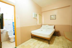 Postel nebo postele na pokoji v ubytování GV Hotel - Tagbilaran City