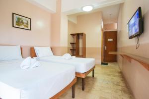 Postel nebo postele na pokoji v ubytování GV Hotel - Tagbilaran City
