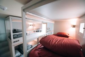 a small bedroom with a bed and a book shelf at Daegu Midtown Hostel in Daegu
