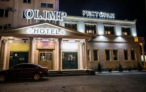 a hotel with a car parked in front of it at Hotel Olimp in Orenburg