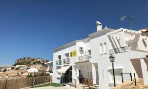 a white house with a hill in the background at Mirador Tierra de Frontera in Alcalá la Real