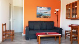 a living room with a couch and a table at Apartaments California in Cala en Blanes