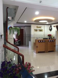 a lobby of a store with a counter and flowers at Khách sạn Thu Thảo in Phan Rang