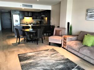 a living room with a couch and a table at 12 Palm Boulevard in Durban