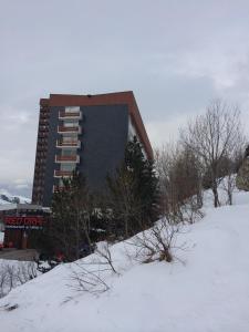 a building in the snow in front at Lauzes in Les Menuires