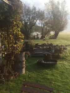 a garden with a bench in the grass at Haus Toquard in Wittmund