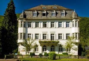 a large white house with a gambrel roof at Haus Hohenzollern & Haus 'Ambiente in Bad Bertrich