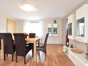 a kitchen and dining room with a table and chairs at Cozy Holiday Home in Hohenkirchen near Baltic Sea in Hohenkirchen