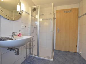 a bathroom with a sink and a shower at Cozy Holiday Home in Hohenkirchen near Baltic Sea in Hohenkirchen