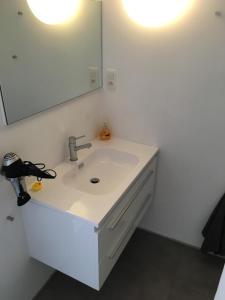 a bathroom with a sink and a mirror at Appartement Thea in Middelkerke